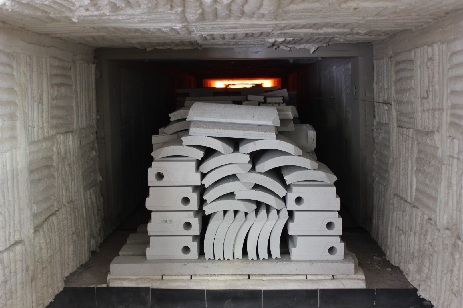 Densely arranged industrial furnace load showing how component position and spacing affect heating